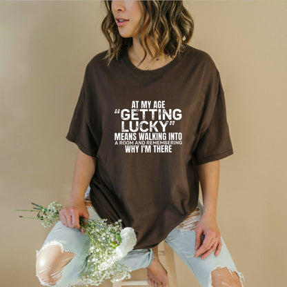 "At My Age Getting Lucky" Funny T-Shirt – Sarcastic Aging Humor Graphic Tee, Unisex Cotton Shirt - Teezioo